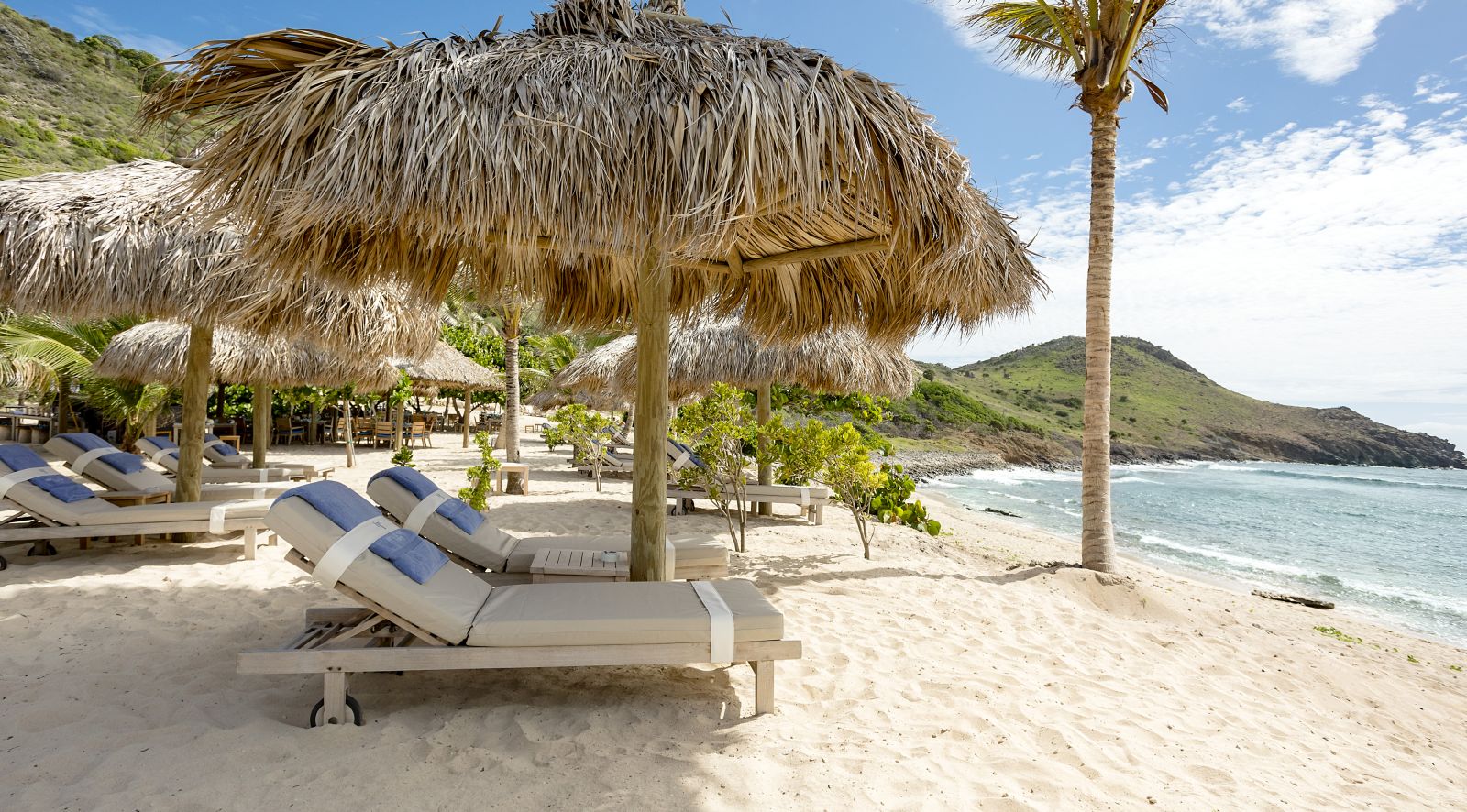 Sunbeds and umbrellas on the beach at Hotel Le Toiny