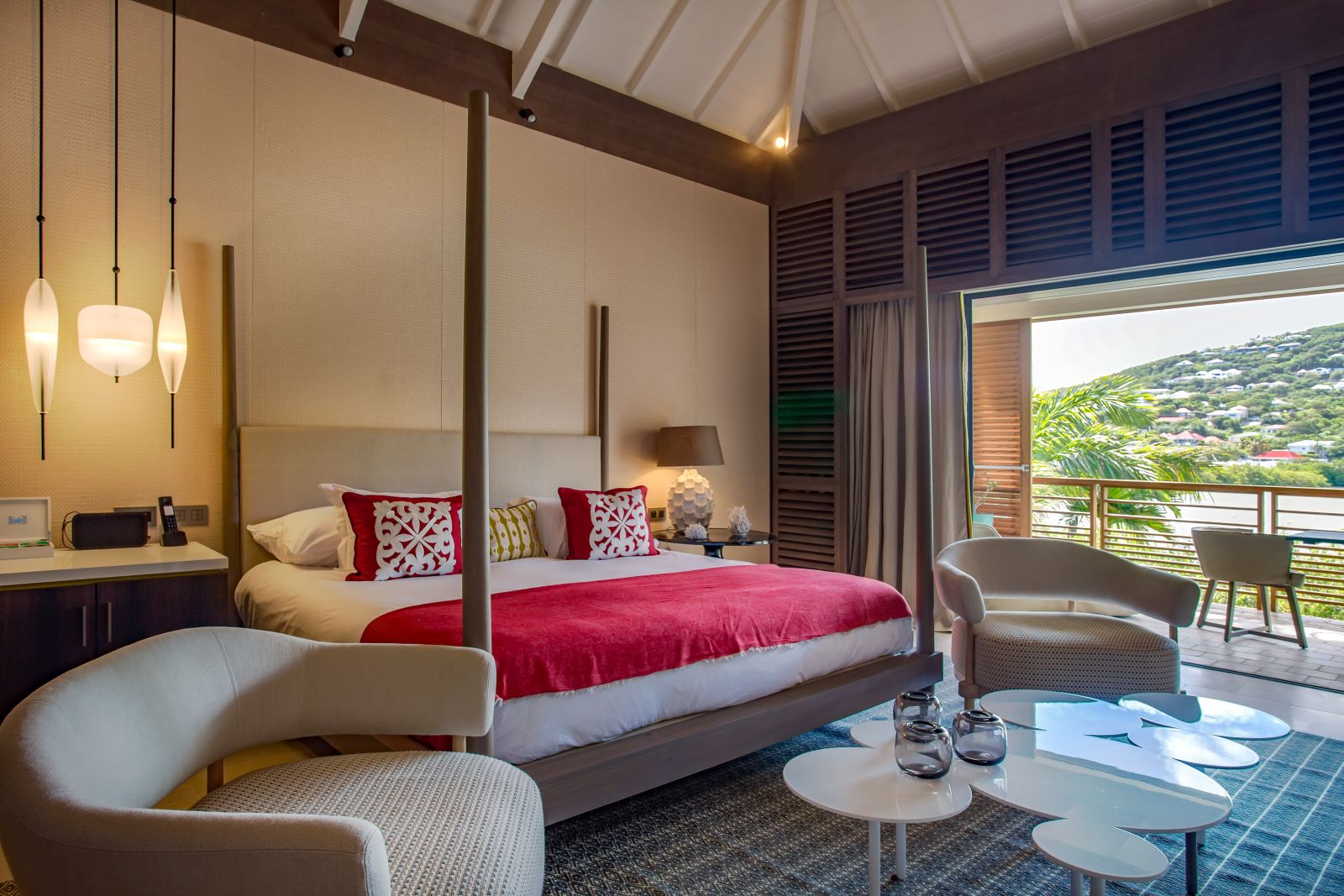 A bedroom suite with an outdoor balcony at Le Barthelemy Hotel & Spa in St Barths