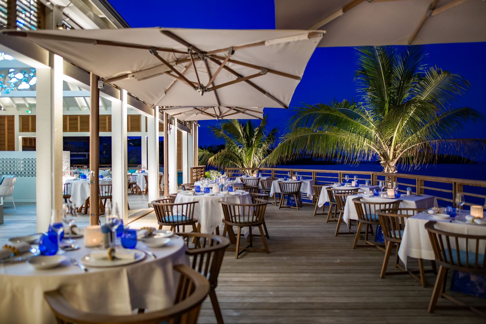 The outdoor restaurant area in the evening at Le Barthelemy Hotel & Spa in St Barths