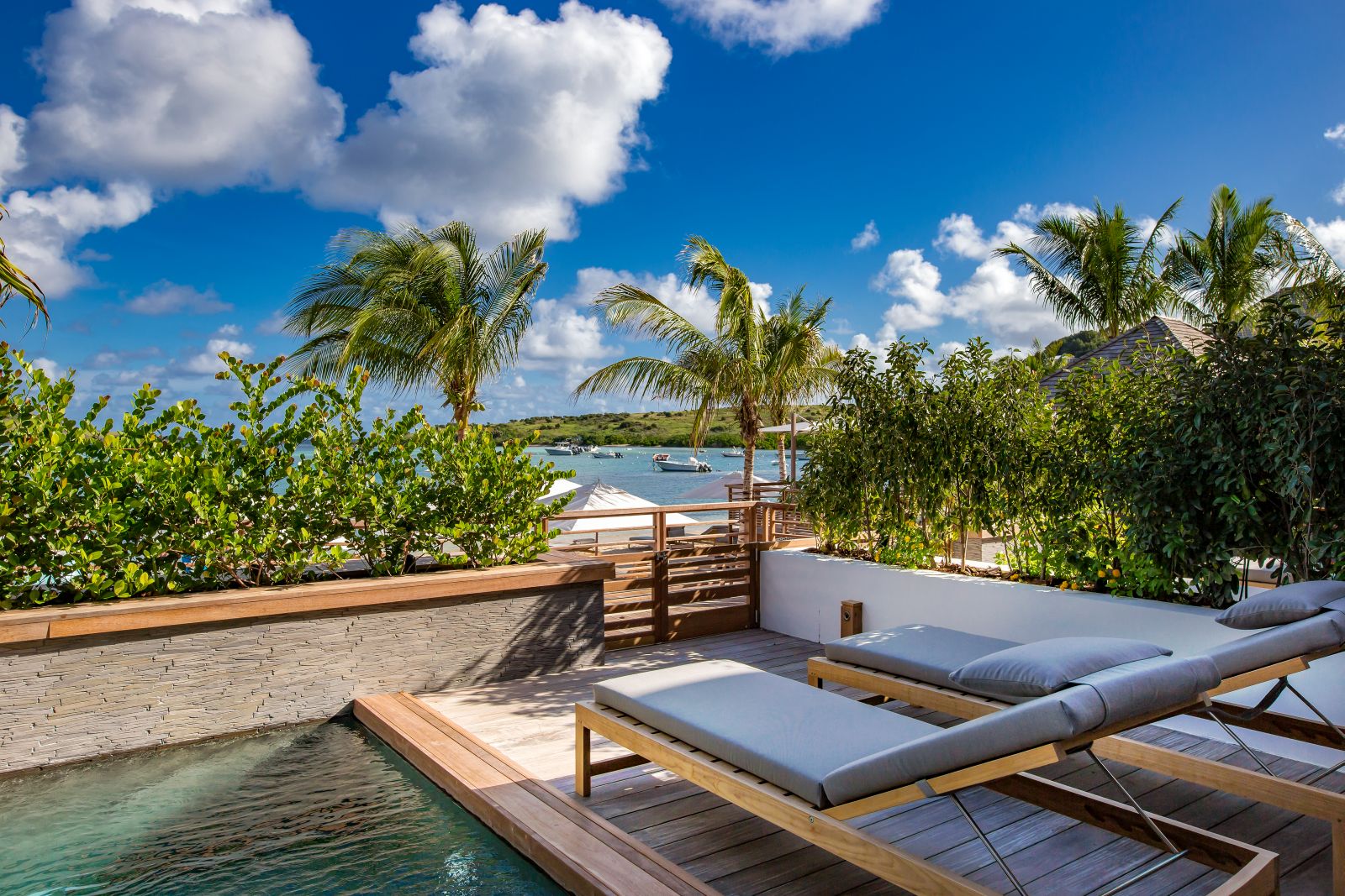 Two sun loungers by the side of a private pool at Le Barthelemy Hotel & Spa in St Barths