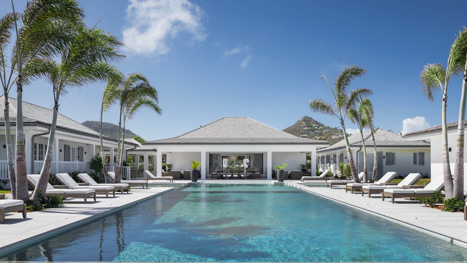Villa Blanc, St Barths - pool terrace and sun loungers beneath palm trees
