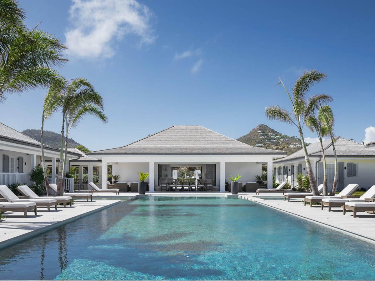 Villa Blanc, St Barths - pool terrace and sun loungers beneath palm trees