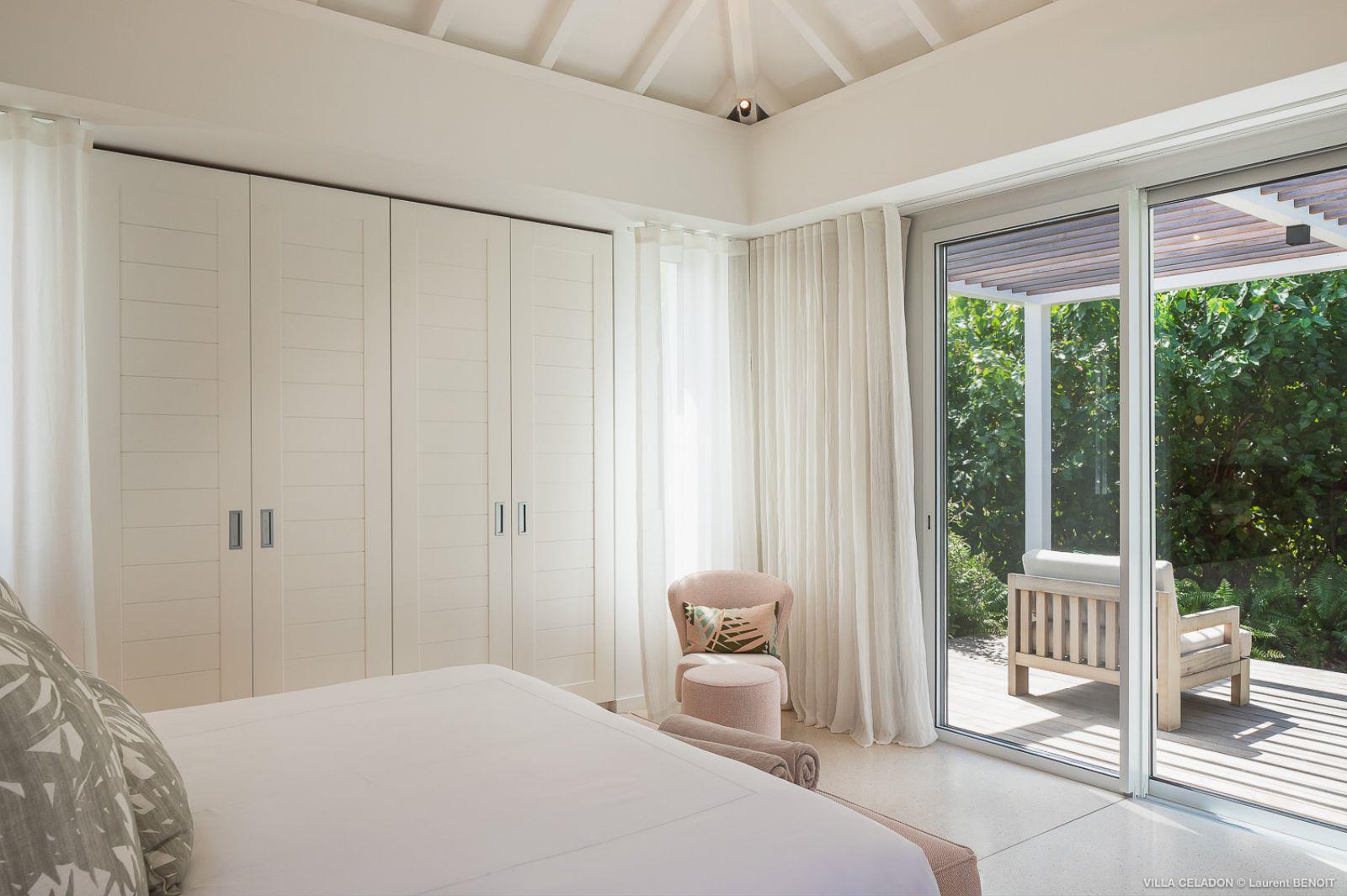 white double bed with door to terrace