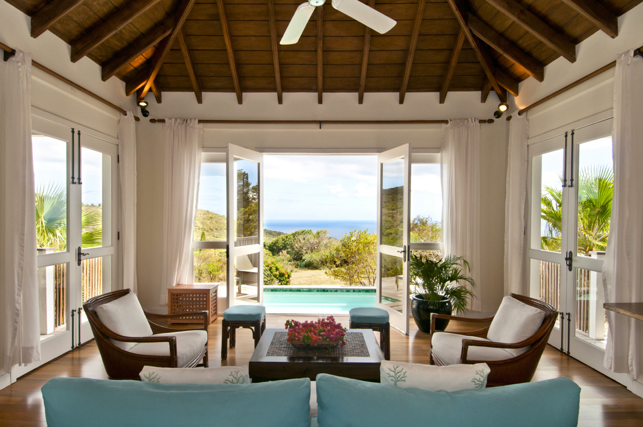Seating area of Tamarind Villa with view of pool, gardens and the ocean