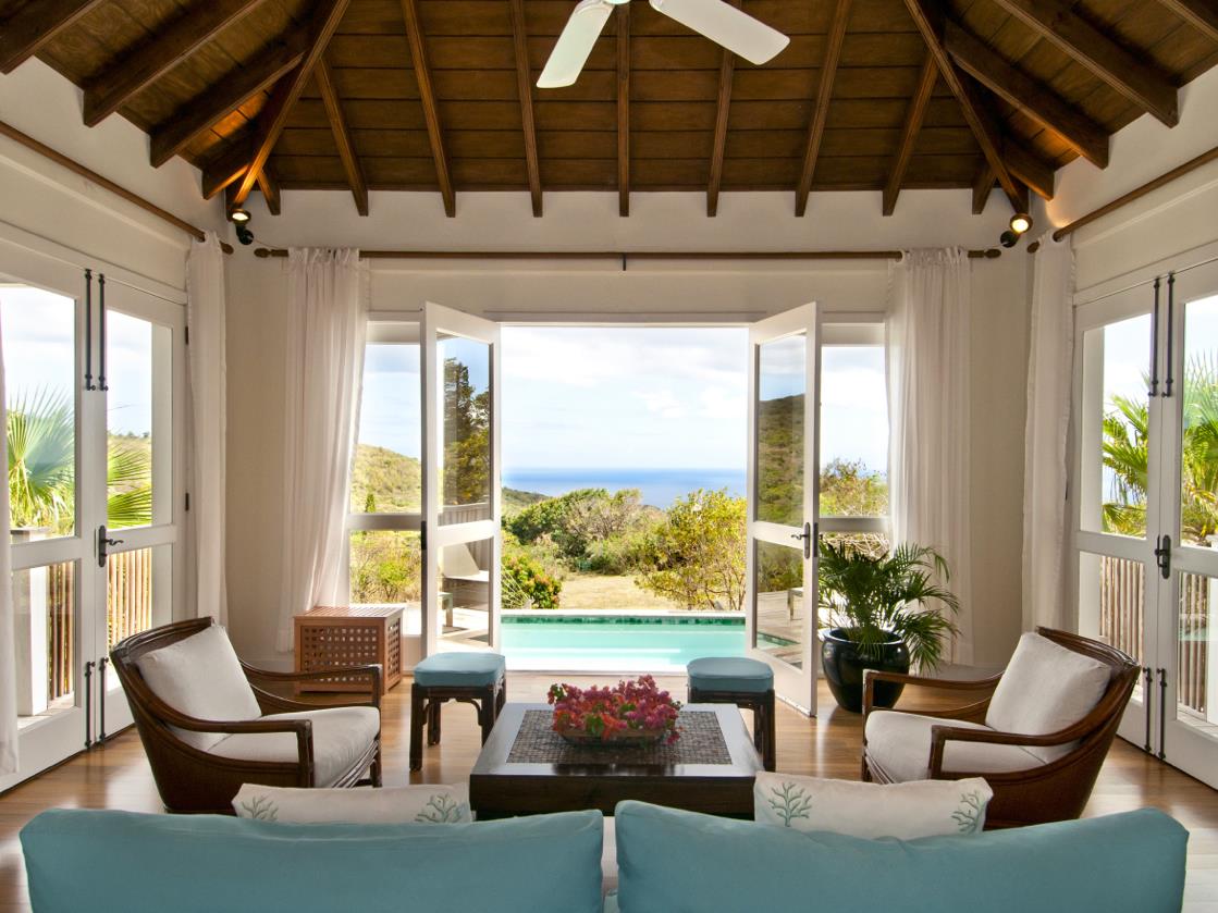 Seating area of Tamarind Villa with view of pool, gardens and the ocean