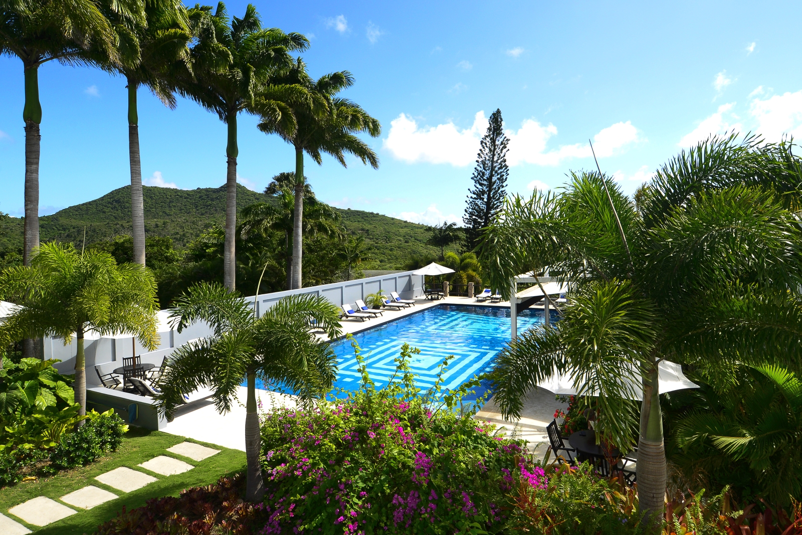 Pool surrounded by lush green gardens at Montpelier Nevis