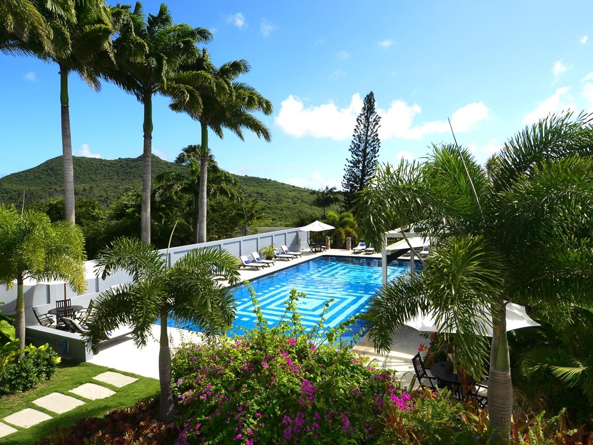 Pool surrounded by lush green gardens at Montpelier Nevis
