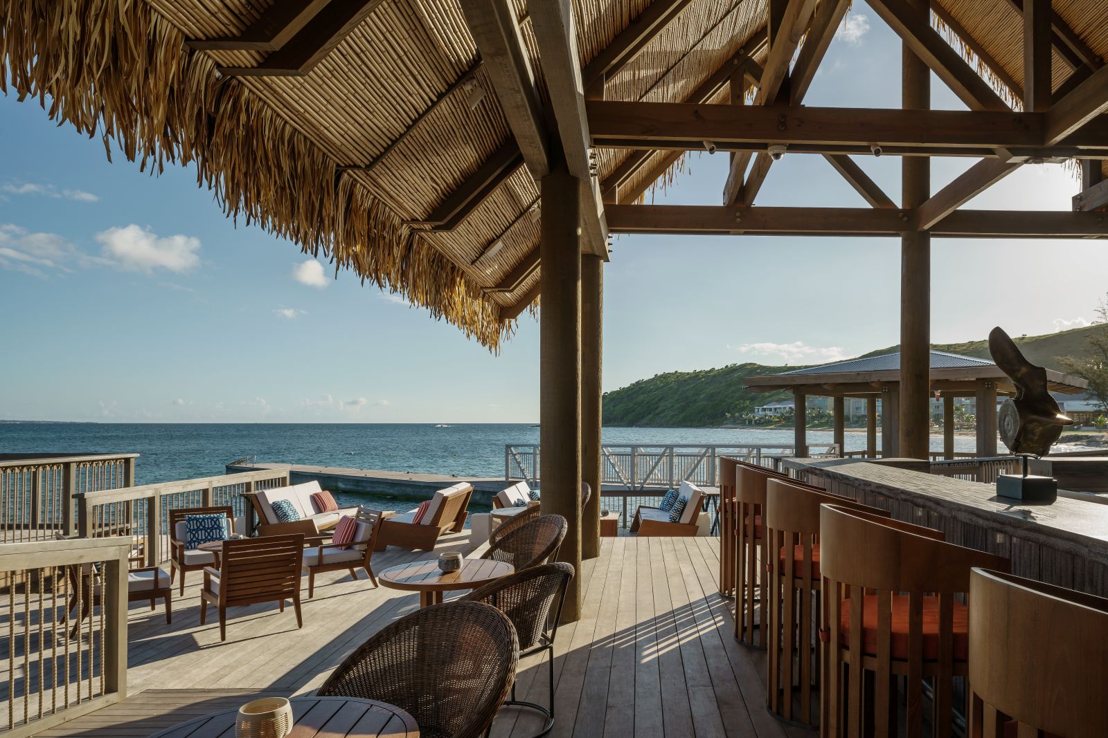 The bar and seating area on the decking overlooking the sea at the Park Hyatt St. Kitts Christophe Harbour Hotel