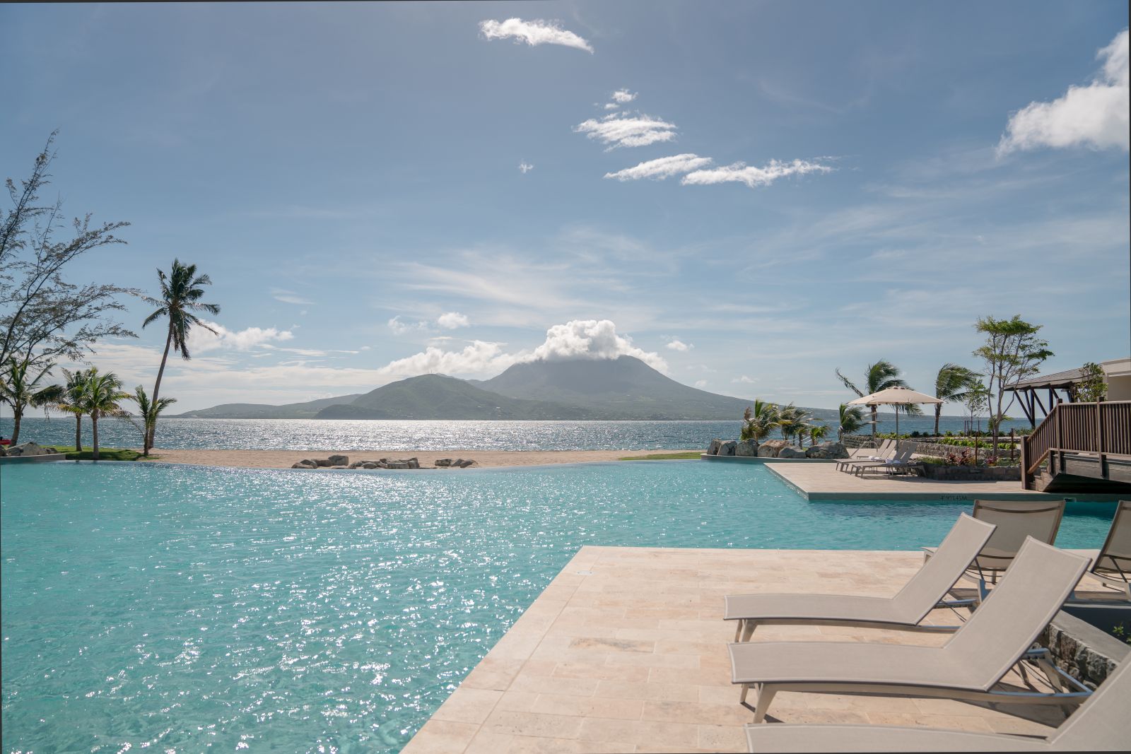 Sun loungers on the edge of the exterior lagoon at the Park Hyatt St. Kitts Christophe Harbour Hotel