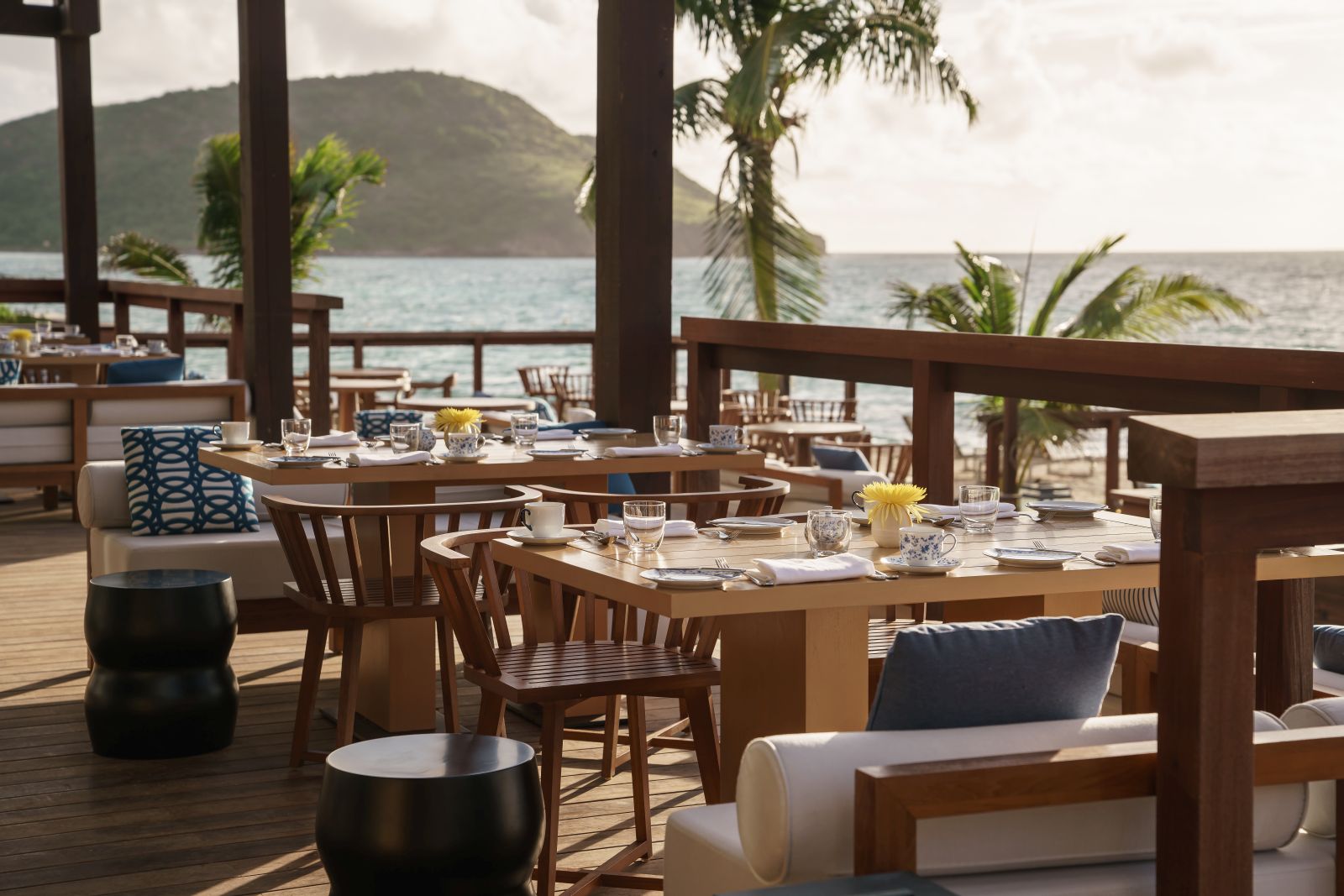 An outside dining area overlooking the beach at the Park Hyatt St. Kitts Christophe Harbour Hotel