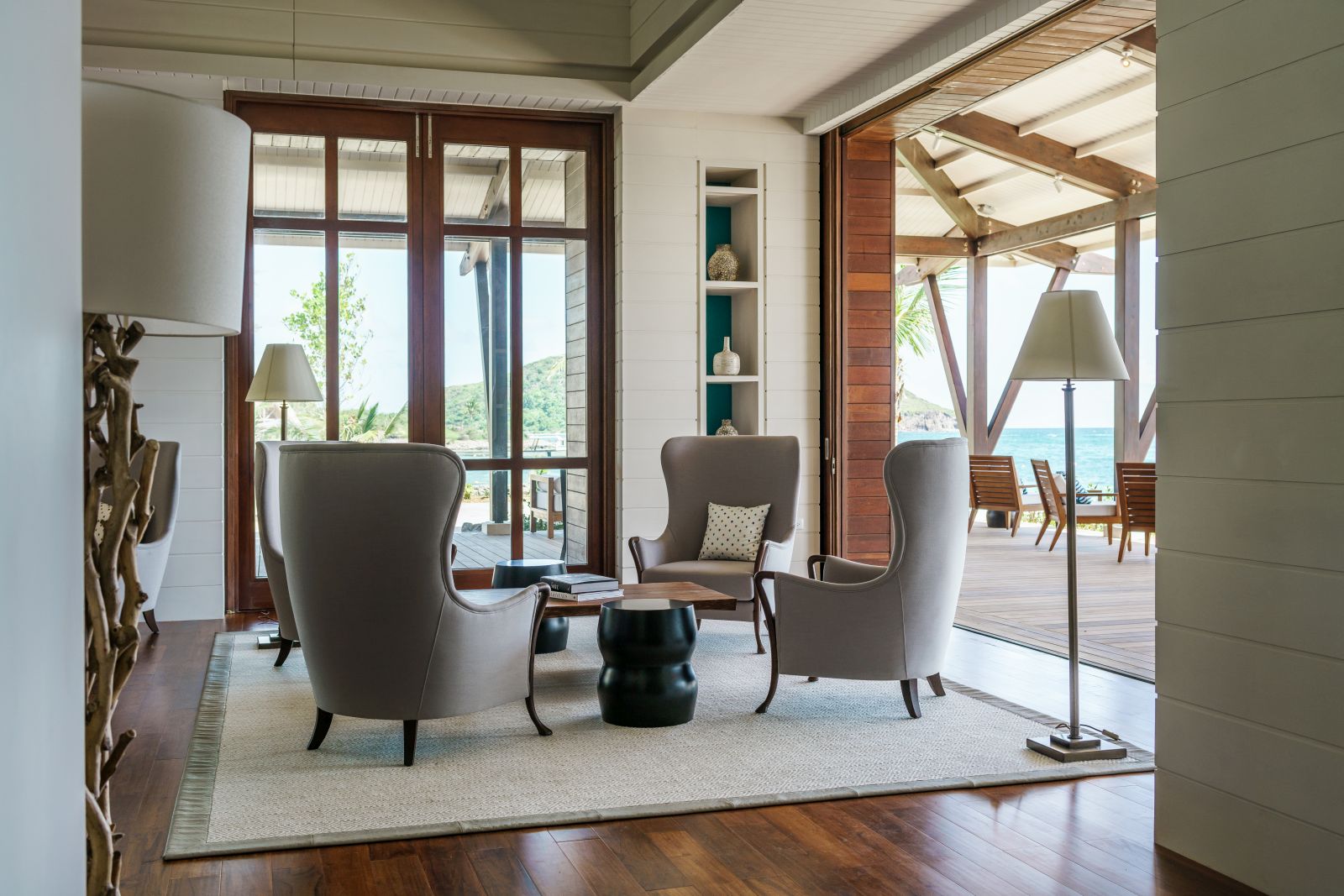Four high backed chairs and a small table in the library at the Park Hyatt St. Kitts Christophe Harbour Hotel 