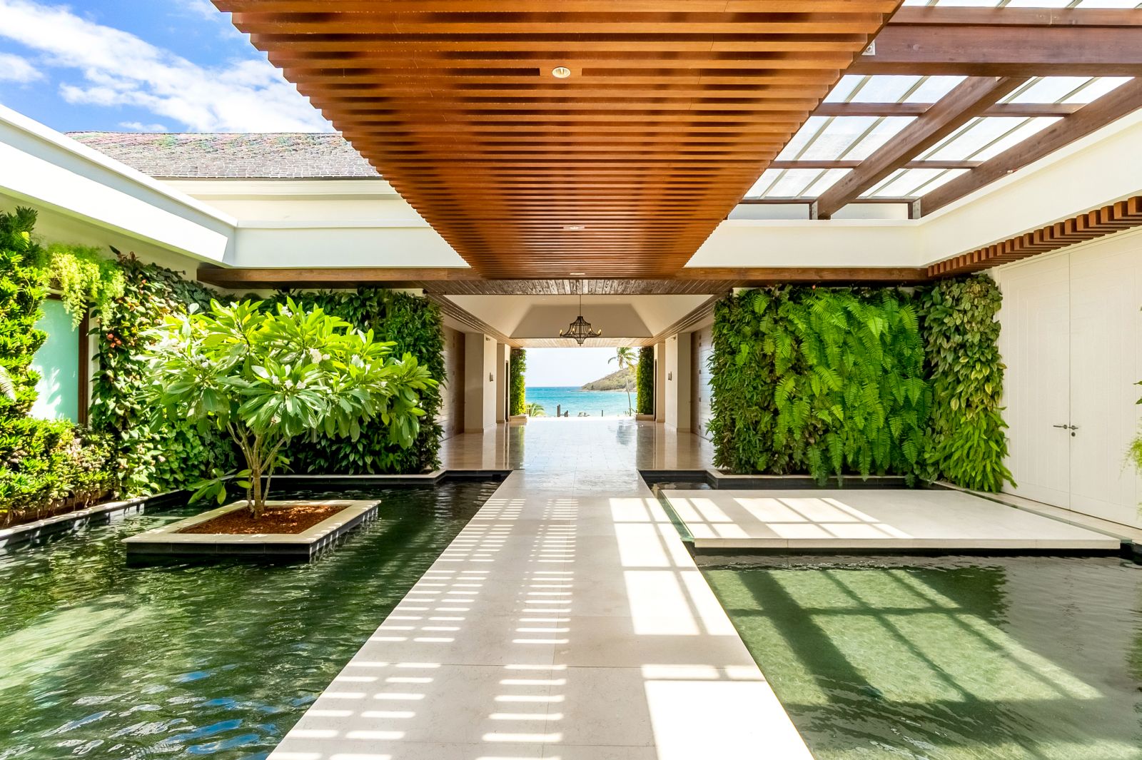 A white marble covered walkway heading to the beach at the Park Hyatt St. Kitts Christophe Harbour Hotel