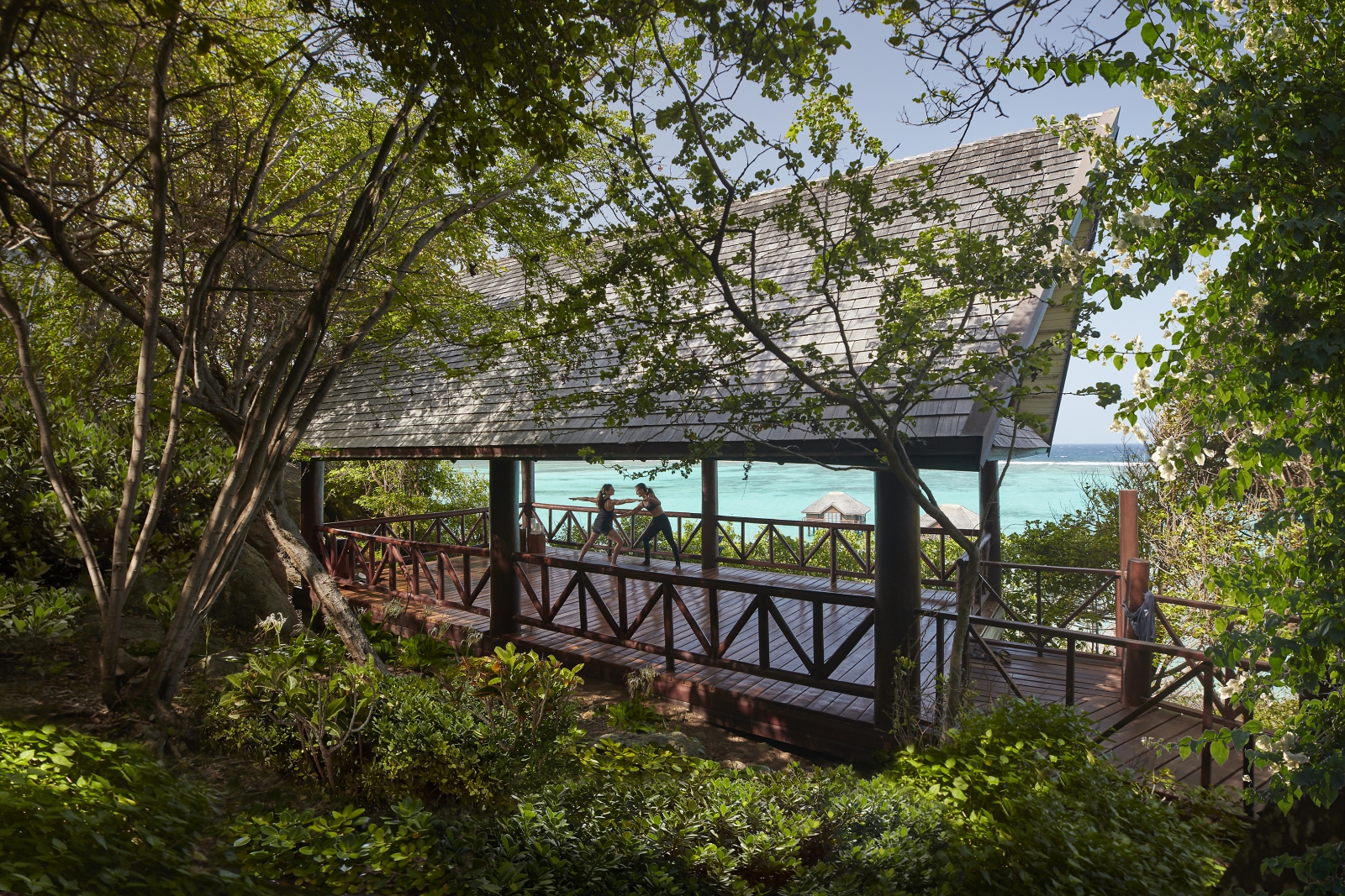 The yoga pavilion at the Mandarin Oriental Canouan, surrounded by lush gardens and overlooking the ocean