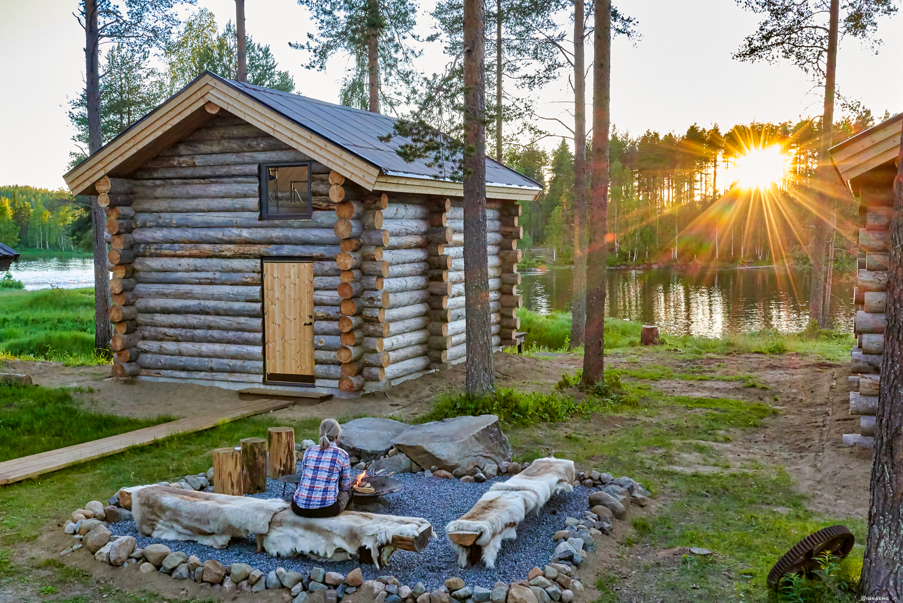 Exterior view of a log cabin at Arctic Retreat in autumn in Swedish Lapland
