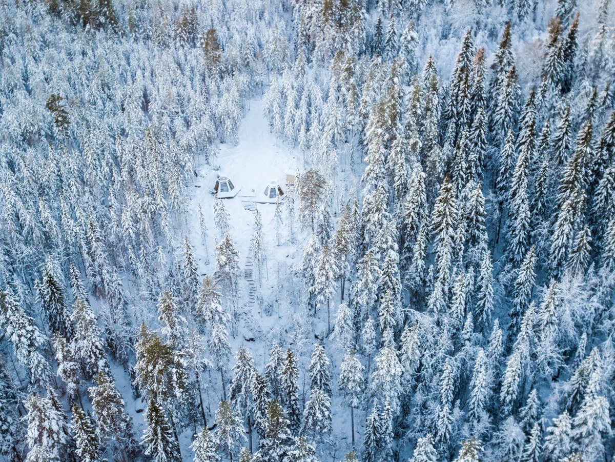 Aerial view of two Cone Rooms in the Swedish forest at Aurora Safari Camp