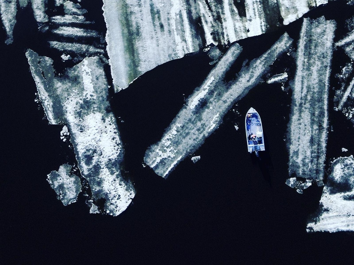 Aerial view of a boat surrounded by ice at Aurora Safari Camp in Sweden
