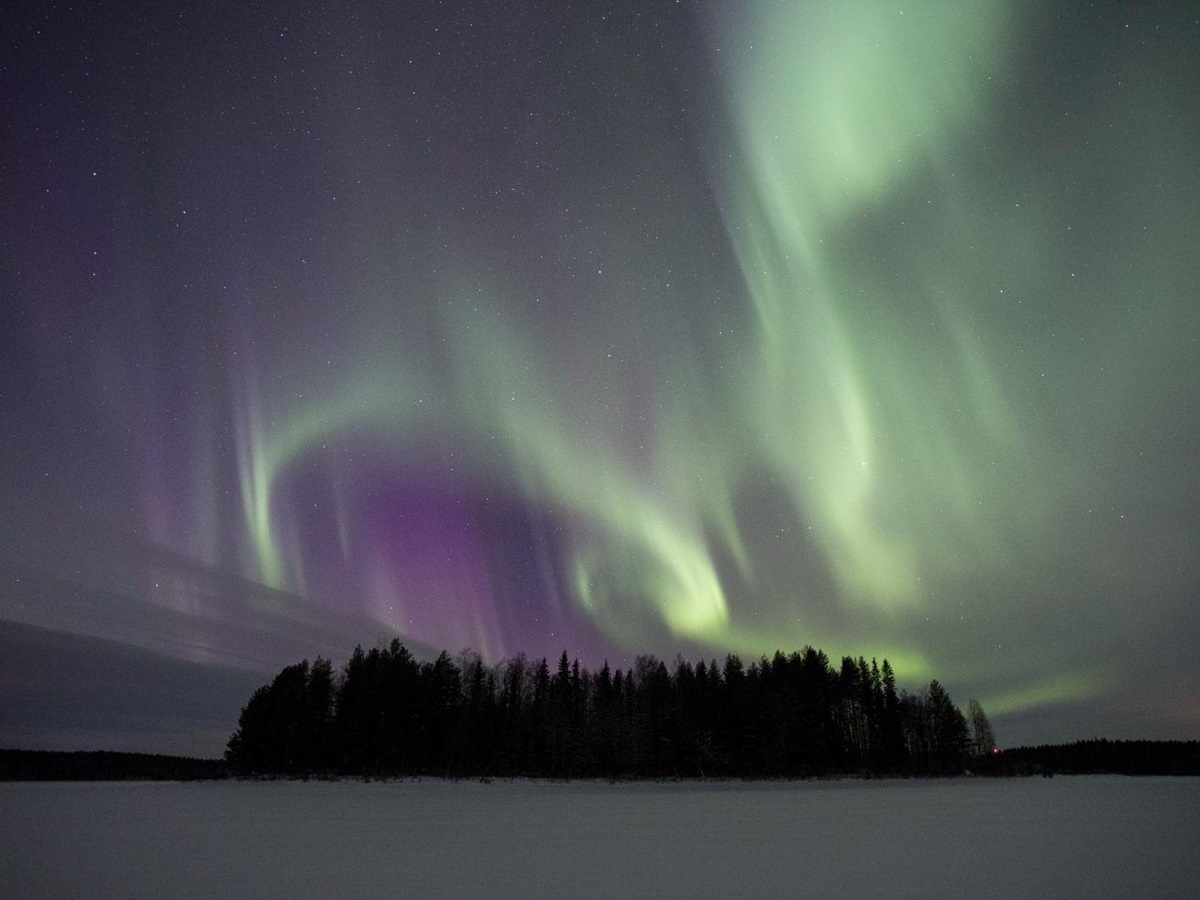 The Northern Lights playing over Aurora Safari Camp in Sweden