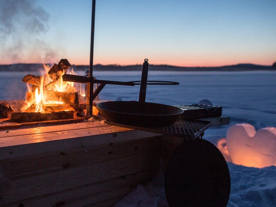 Bonfire on the ice at Aurora Safari Camp in Sweden