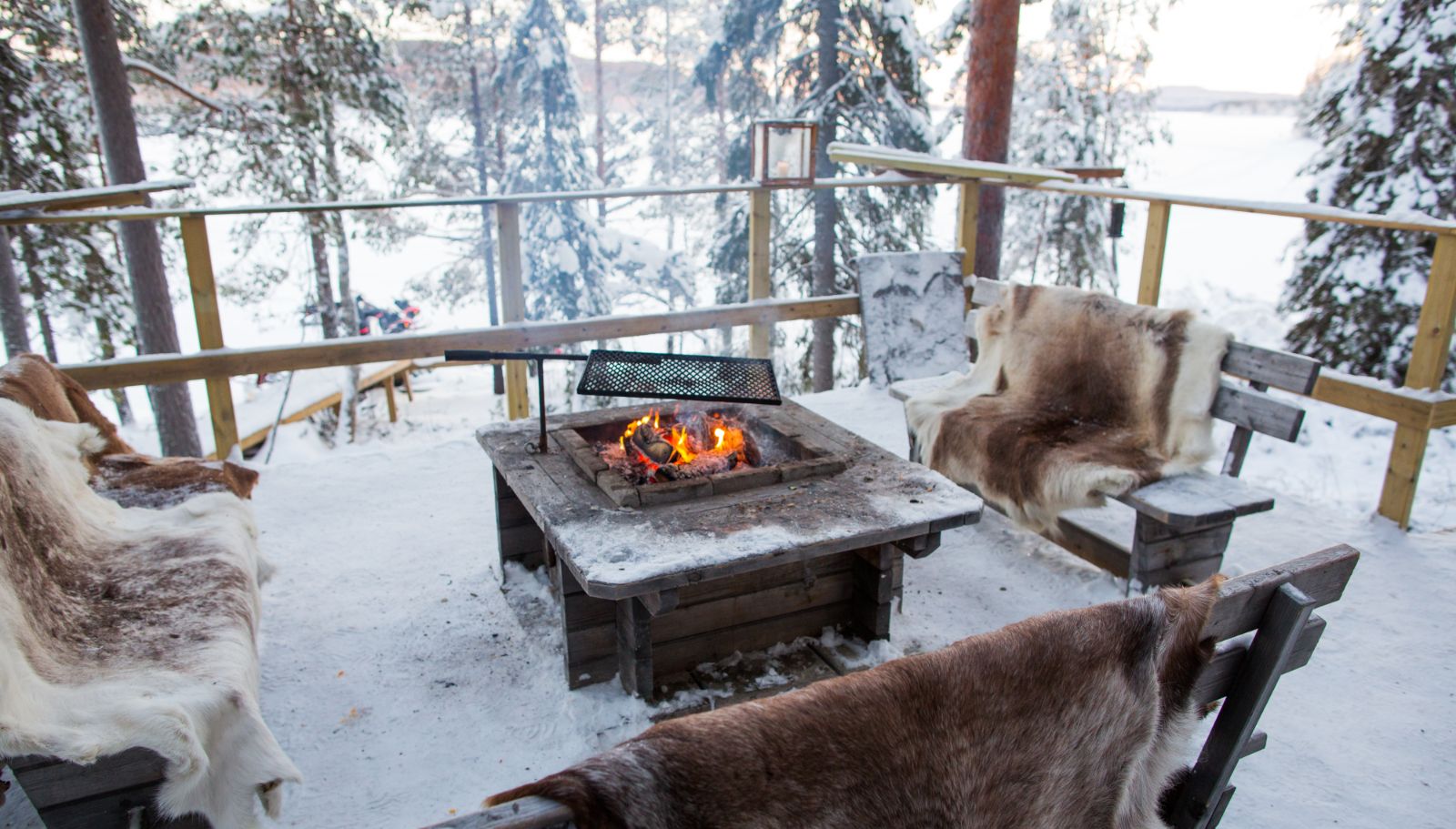 Bonfire in the snow at Aurora Safari Camp in Sweden