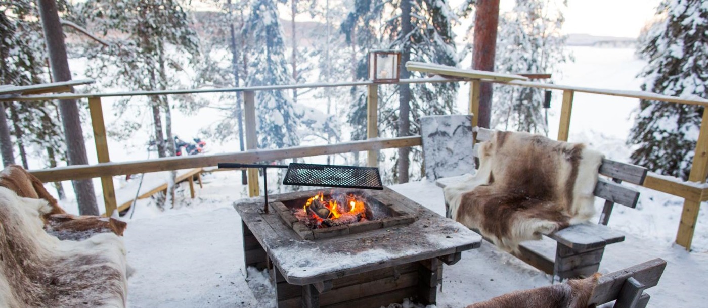Bonfire in the snow at Aurora Safari Camp in Sweden