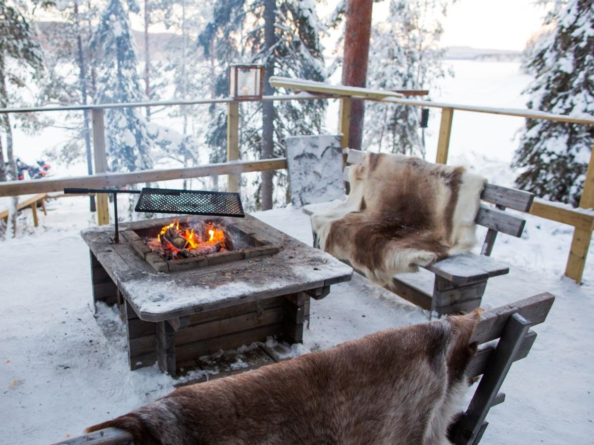 Bonfire in the snow at Aurora Safari Camp in Sweden