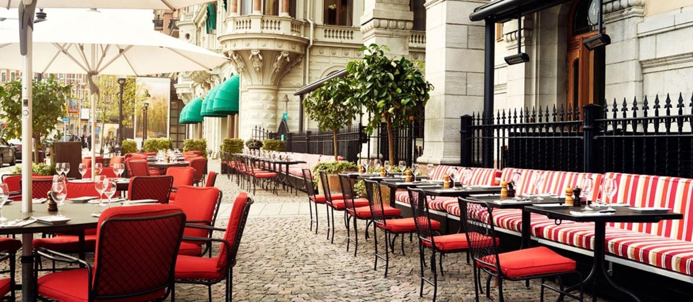 Outdoor seating on a cobbled square with parasols