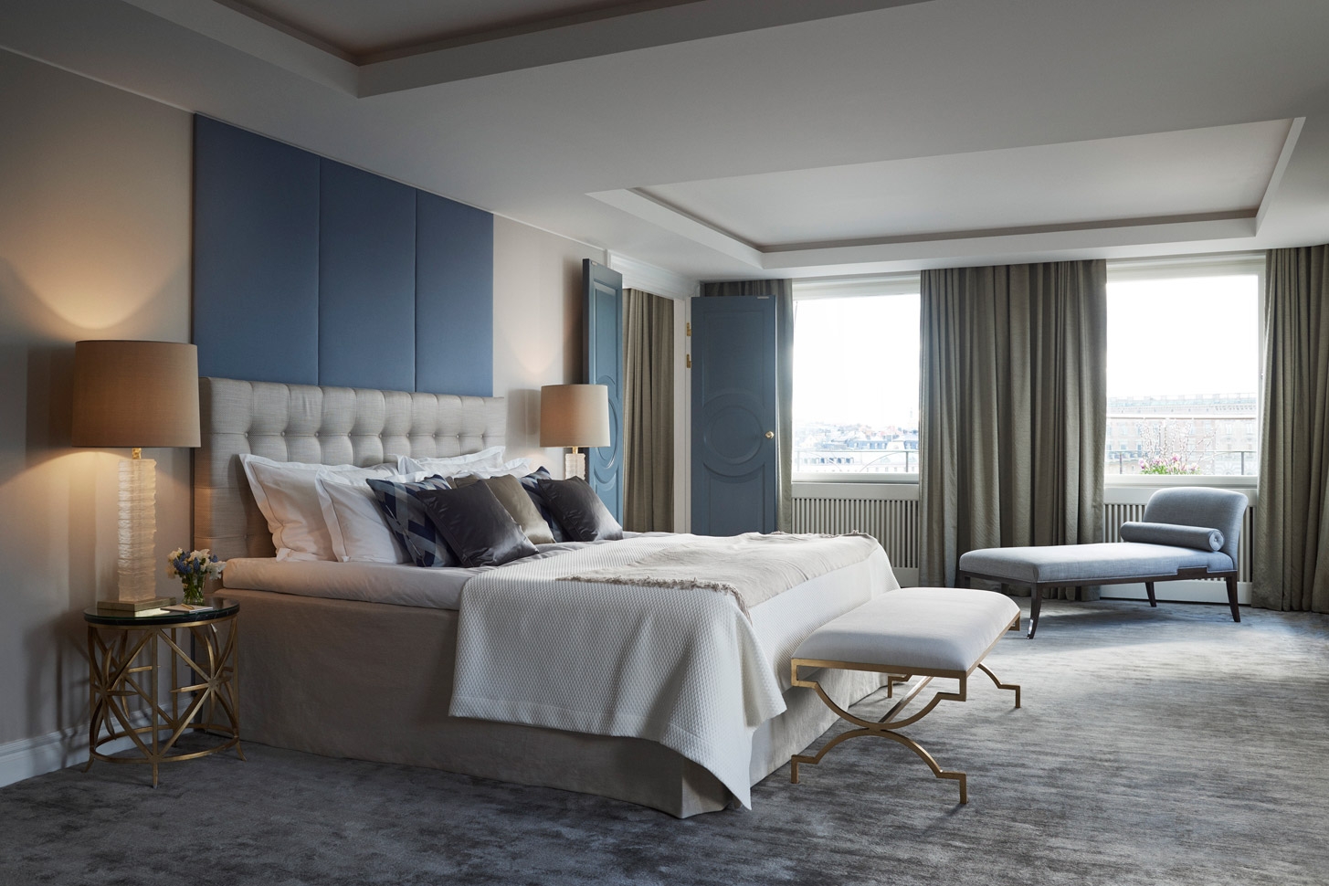 Bright and modern bedroom of a suite with views over the city
