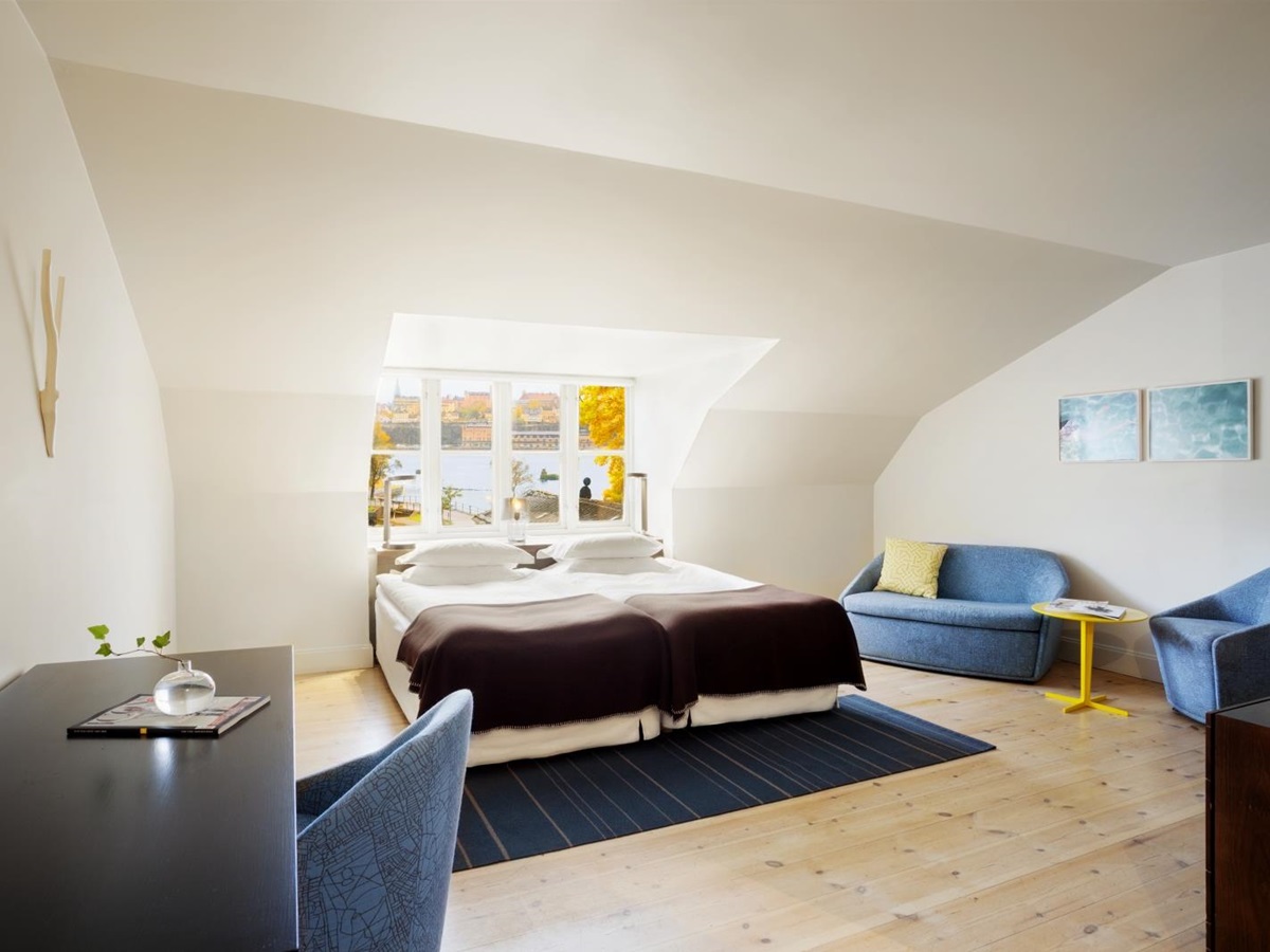 Spacious Deluxe room with desk and sitting area at Hotel Skeppsholmen