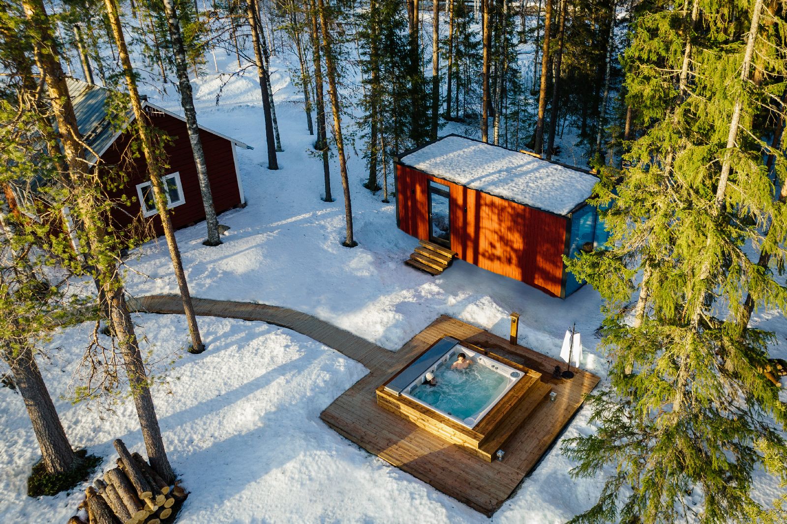 Aerial view of outdoor hot tub with forest views st luxury Loggers Lodge hotel in Sweden