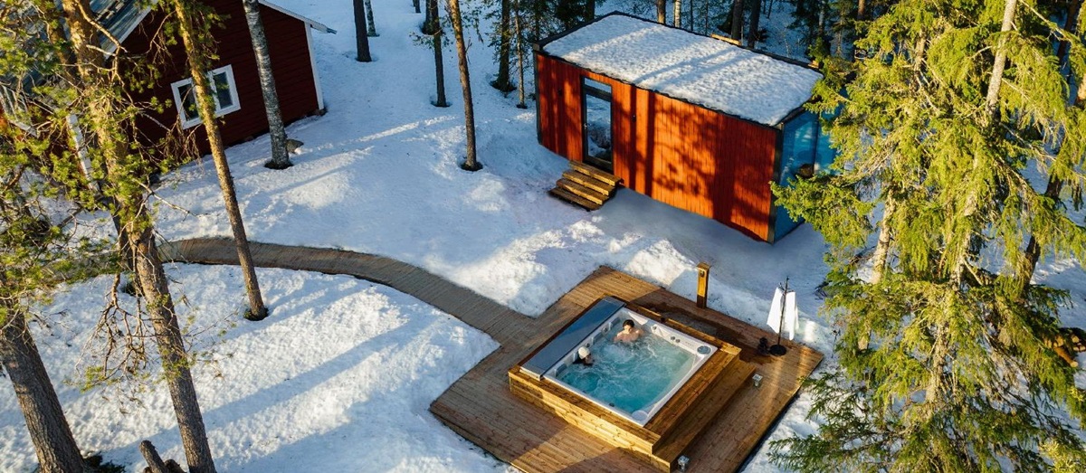 Aerial view of outdoor hot tub with forest views st luxury Loggers Lodge hotel in Sweden