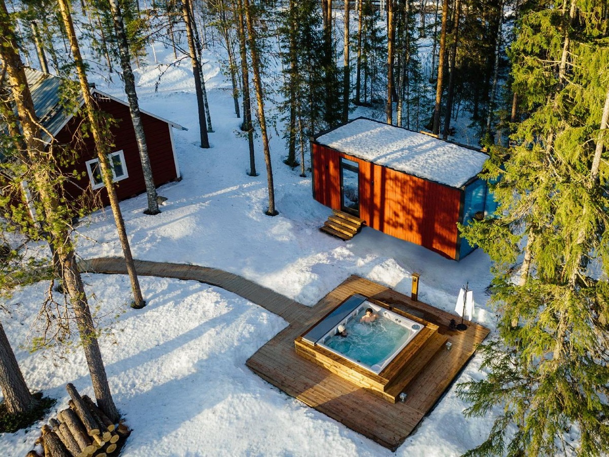Aerial view of outdoor hot tub with forest views st luxury Loggers Lodge hotel in Sweden