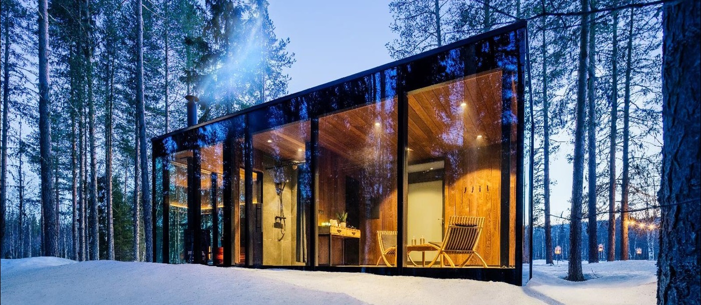 Private sauna with forest and snow views at luxury Loggers Lodge hotel in Sweden