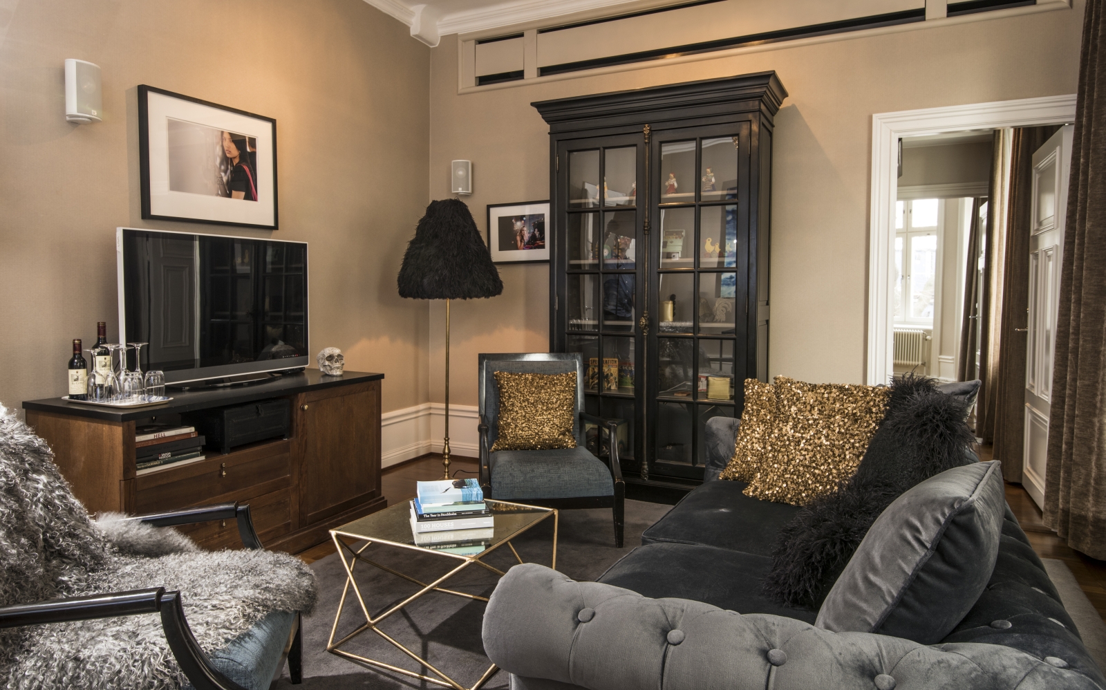 Sitting area of the suite at Lydmar hotel, with grey sofas and gold accents