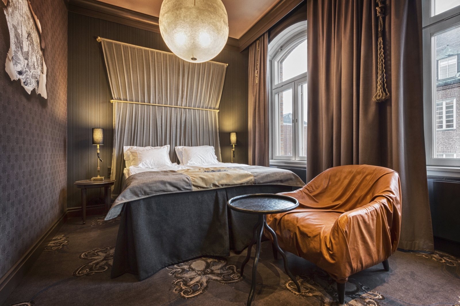 Double Bed with chair and small table at Stora Hotellet