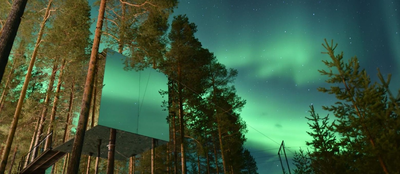 Mirror cube and Northern Lights at the Treehotel in Sweden