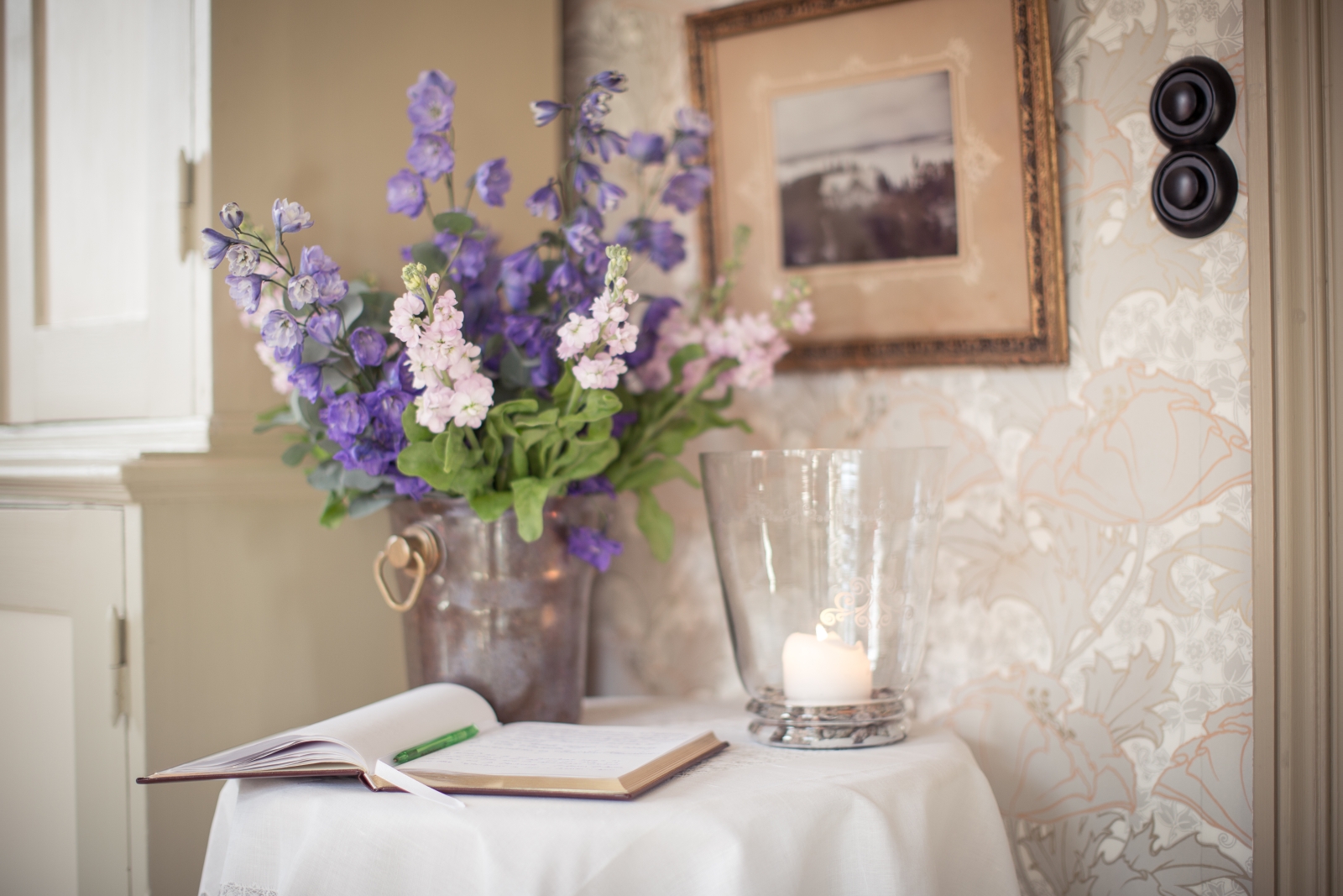 Guestbook area with fresh flowers at Villa Sjotorp in Sweden