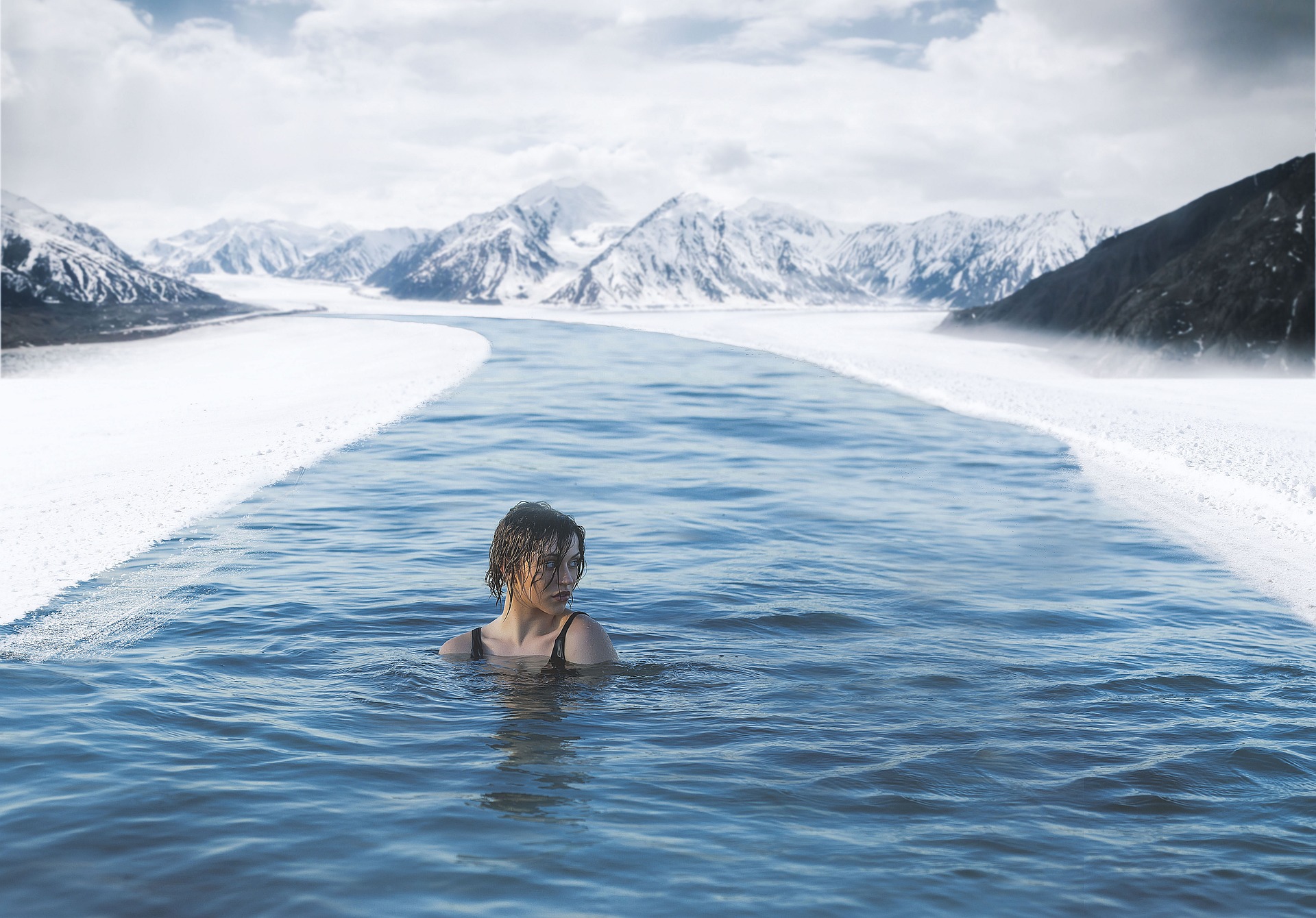 Woman swimming in a frozen lake