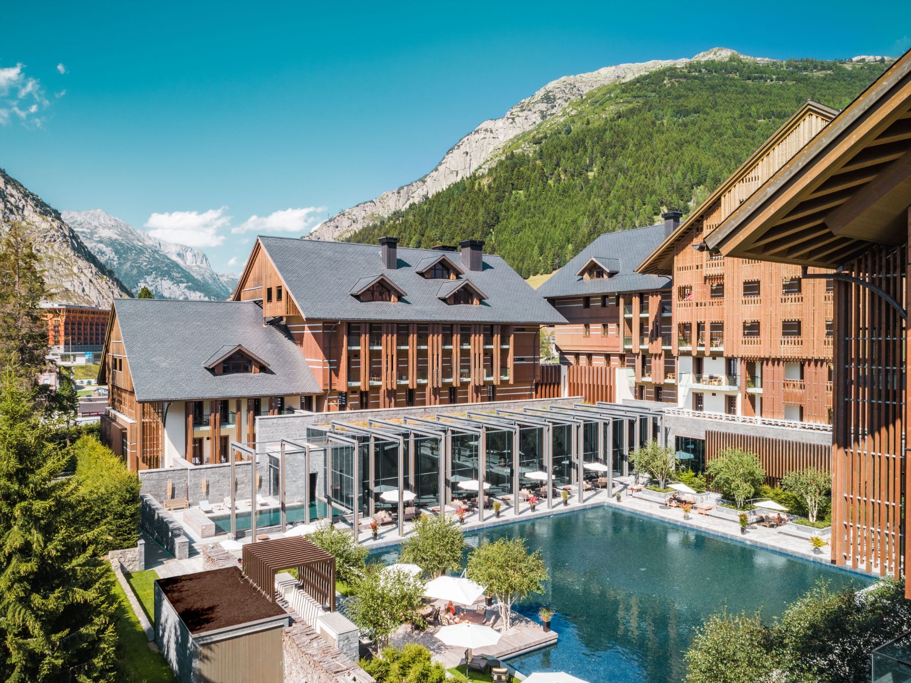 The outdoor swimming pool and terrace at Chedi Andermatt Switzerland