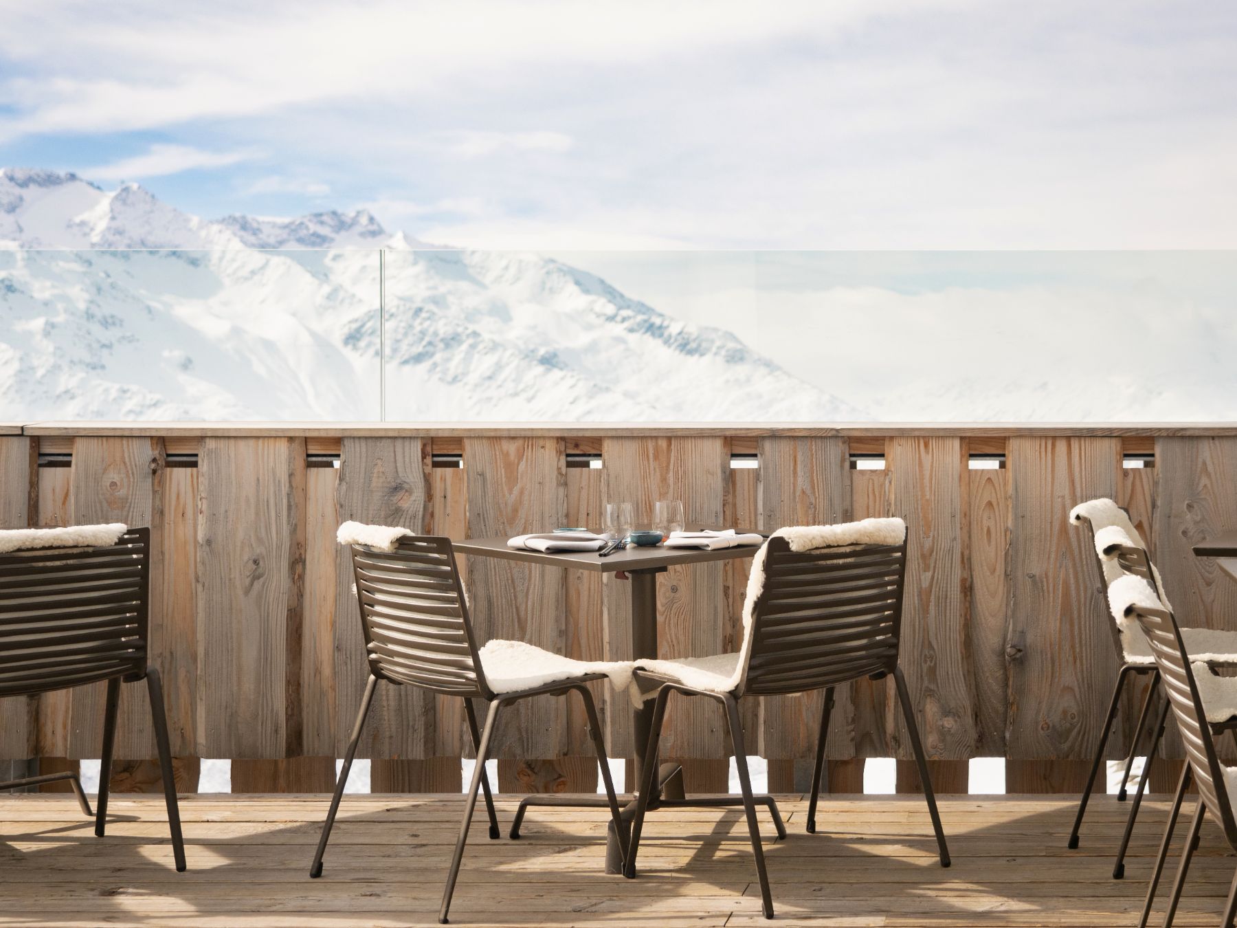 View of snowy mountains from a terrace at Chedi Andermatt Switzerland