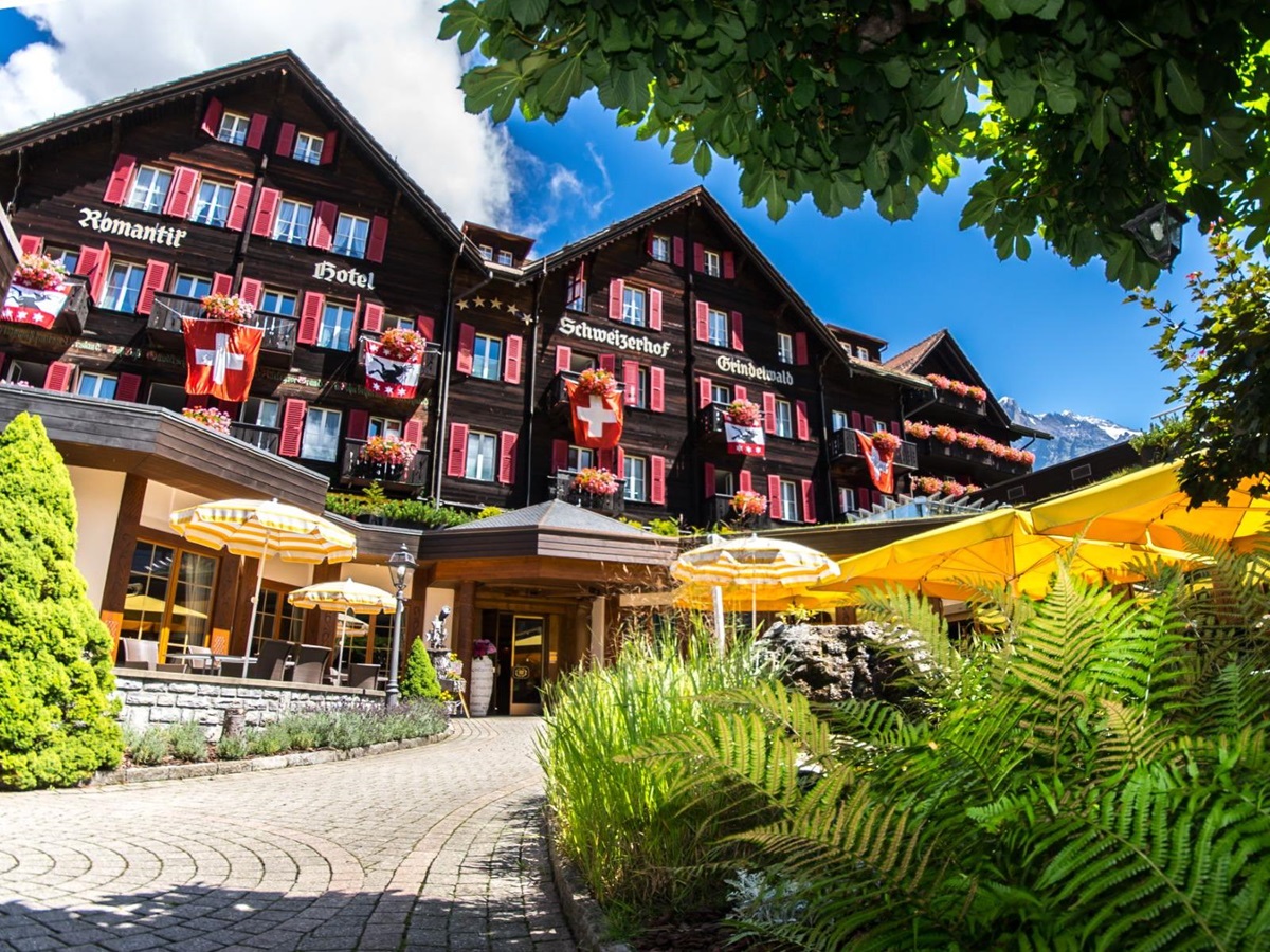 Exterior view of Hotel Schweizerhof in Zermatt during the summer