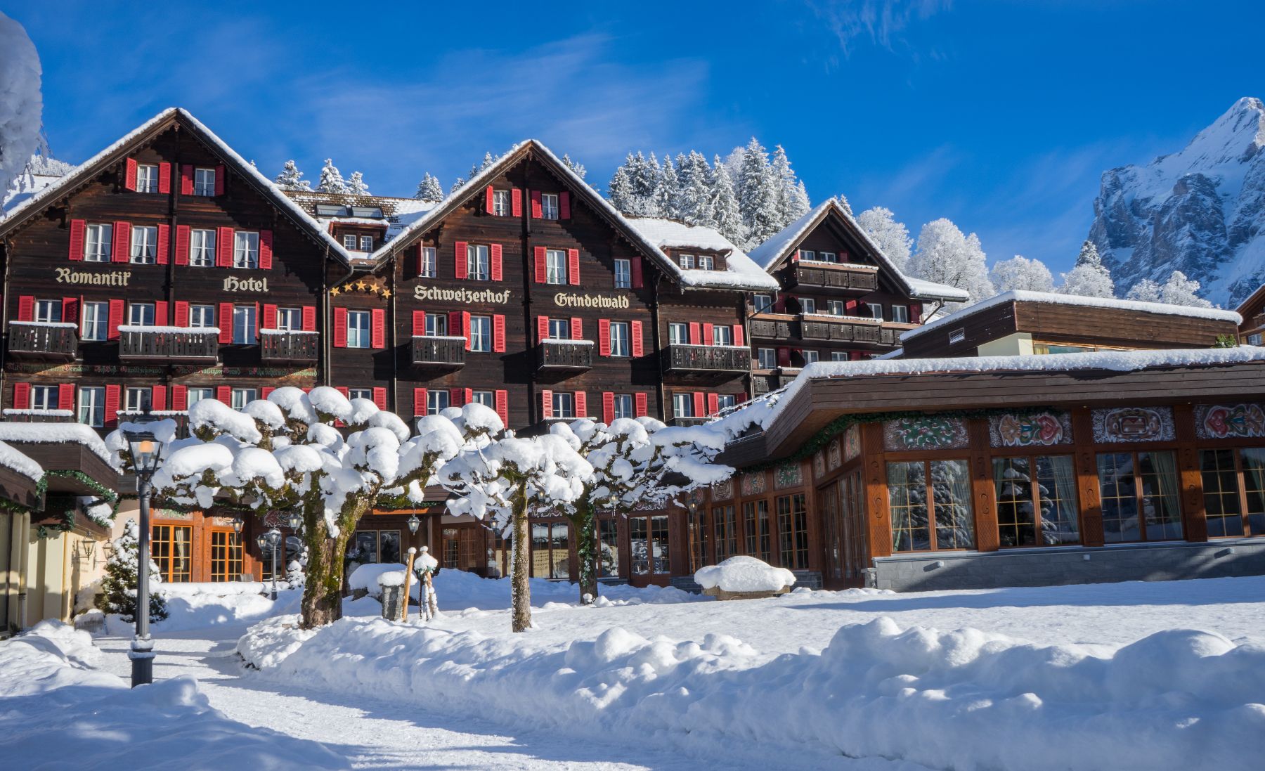 Exterior view of Hotel Schweizerhof in Zermatt during winter