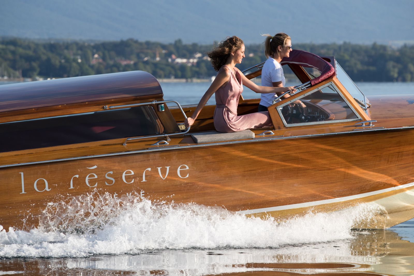Guests enjoying the hotel's private boat at La Reserve Geneva Switzerland
