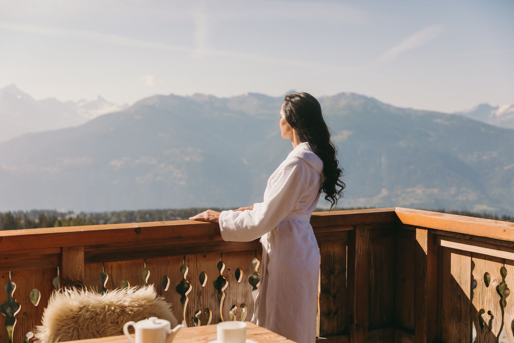 A woman on the balcony at Le Crans in Switzerland
