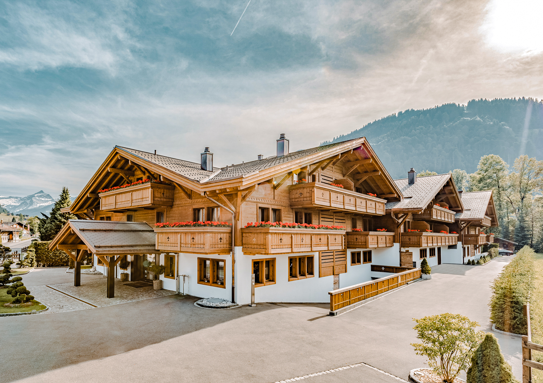 Exterior view of Ultima Hotel Gstaad in Switzerland during summer