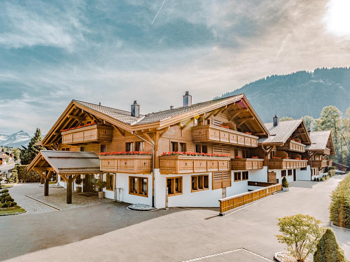 Exterior view of Ultima Hotel Gstaad in Switzerland during summer