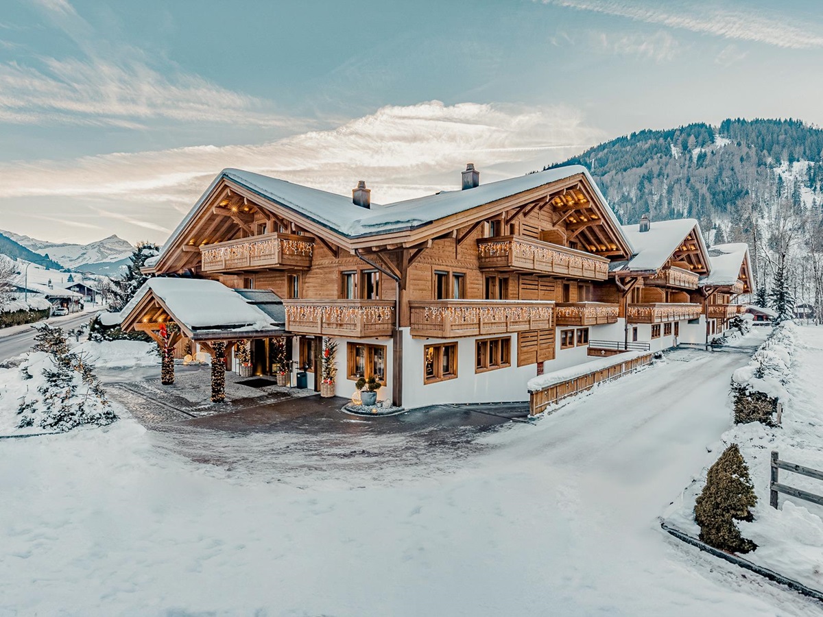 Exterior view of Ultima Hotel Gstaad in Switzerland during winter