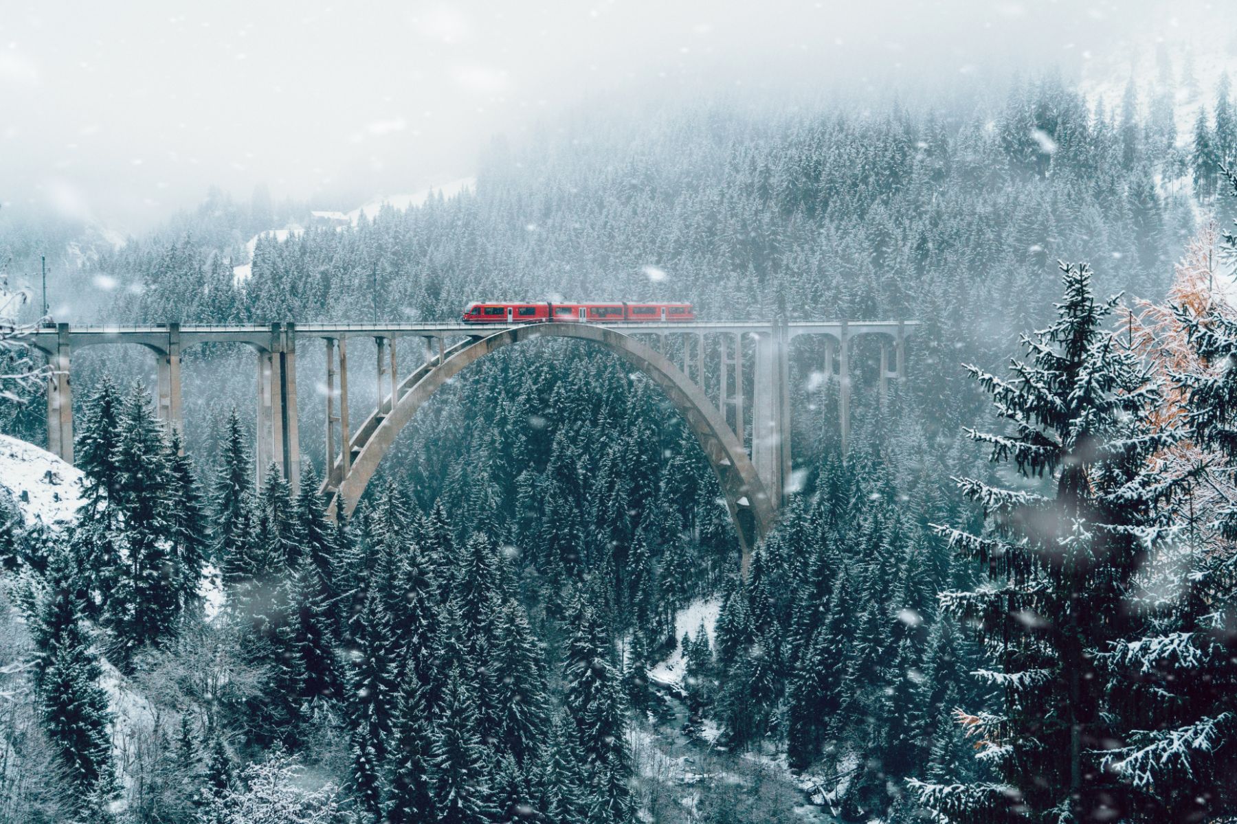 A train travelling through a snow Swiss landscape