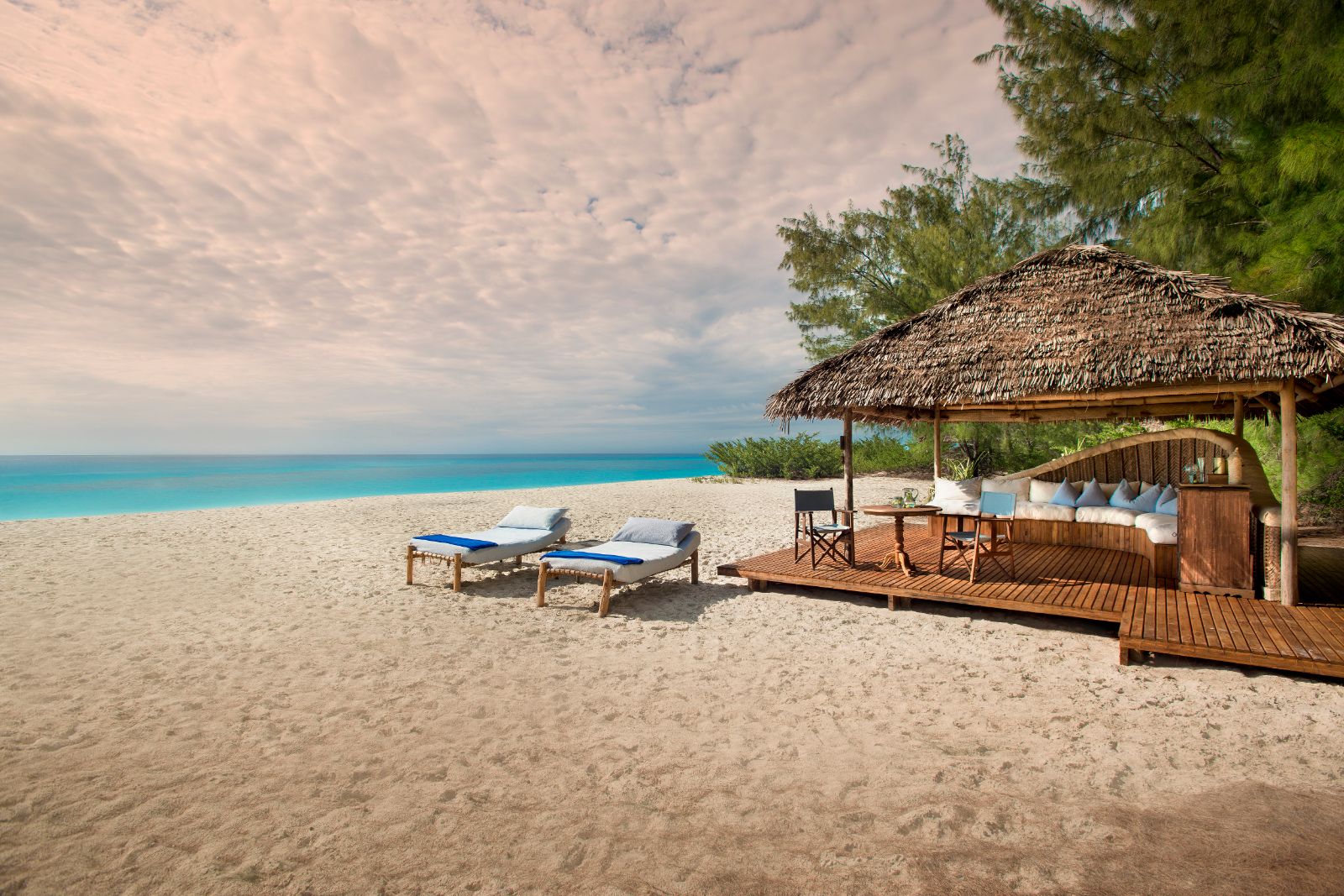 Sun loungers on the beach at andBeyond Mnemba Island Lodge, Zanzibar
