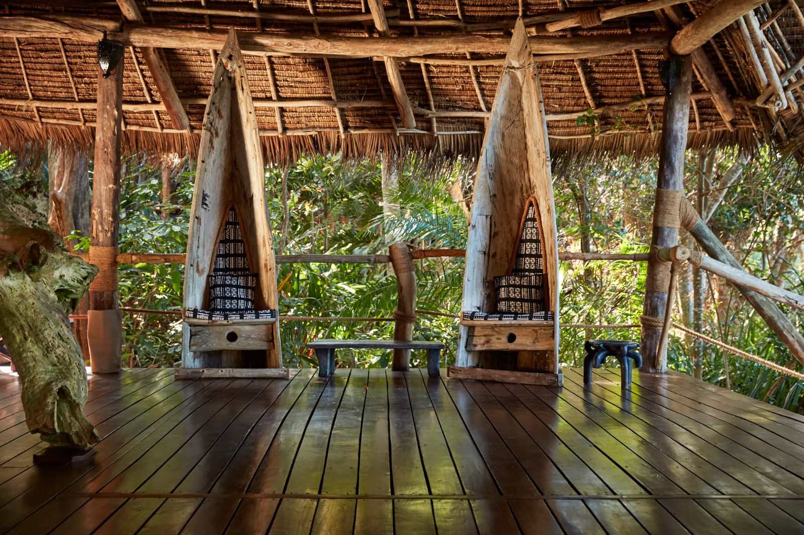 Two chairs made out of canoes in the reception area of luxury hotel Fundu Lagoon on Zanzibar