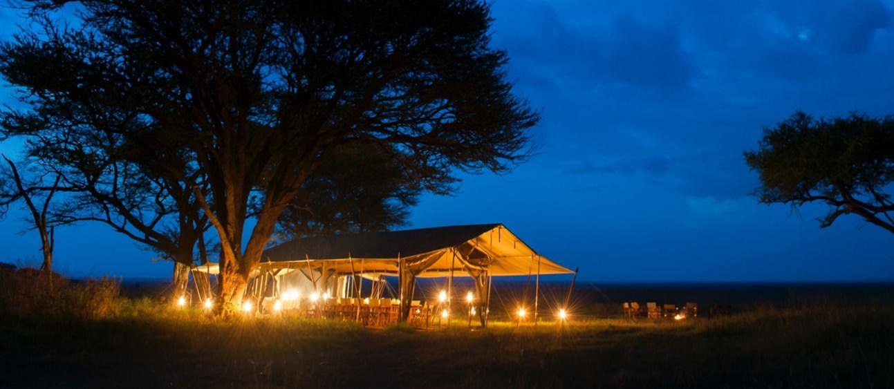 Dining tent at night at Serengeti Safari Camp in Tanzania 